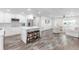 Bright open floor plan seamlessly connects the kitchen and living area with stylish flooring at 3417 50Th W St, Bradenton, FL 34209