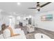 Open-concept living area features shiplap walls, modern ceiling fan, and seamless flow to kitchen at 3417 50Th W St, Bradenton, FL 34209