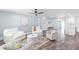 Bright living room features a ceiling fan, comfortable white seating, and stylish fish rug at 3417 50Th W St, Bradenton, FL 34209