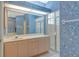 Floral bathroom featuring a vanity, a large mirror, and a glass-enclosed shower at 3870 Alamanda Dr, Sarasota, FL 34238