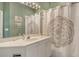 Stylish bathroom featuring a vanity, mirror, and shower with patterned curtain at 3870 Alamanda Dr, Sarasota, FL 34238