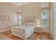 Bright bedroom featuring hardwood floors, a queen sized bed, and french doors at 3870 Alamanda Dr, Sarasota, FL 34238