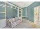 Cozy bedroom with built-in shelves, cabinets, and a floral sofa with desk at 3870 Alamanda Dr, Sarasota, FL 34238