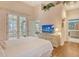 Bright bedroom featuring hardwood floors, a queen sized bed, and french doors at 3870 Alamanda Dr, Sarasota, FL 34238