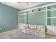 Cozy bedroom with built-in shelves, cabinets, and a floral sofa at 3870 Alamanda Dr, Sarasota, FL 34238