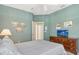 Bedroom featuring a comfortable bed, closet, and dresser with TV at 3870 Alamanda Dr, Sarasota, FL 34238
