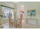 Cozy dining area featuring a glass table, elegant decor, and a view to the kitchen at 3870 Alamanda Dr, Sarasota, FL 34238