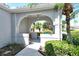 Charming front entry featuring a covered porch with inviting decor and a well-manicured garden view at 3870 Alamanda Dr, Sarasota, FL 34238