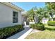 Charming exterior view with a covered entryway, lush landscaping, and a well-maintained walkway at 3870 Alamanda Dr, Sarasota, FL 34238