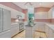 Bright kitchen features an island, appliances, and eat-in breakfast nook at 3870 Alamanda Dr, Sarasota, FL 34238