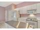 Bright kitchen features an island, appliances, and eat-in breakfast nook at 3870 Alamanda Dr, Sarasota, FL 34238