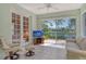Enclosed lanai with tile flooring, a scenic view of the lake, and comfortable seating at 3870 Alamanda Dr, Sarasota, FL 34238