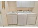Functional laundry room with a sink, washer, and dryer at 3870 Alamanda Dr, Sarasota, FL 34238