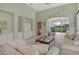 Inviting living room showcases tile floors, built-in shelving, and a view to the screened lanai at 3870 Alamanda Dr, Sarasota, FL 34238