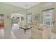 Bright living room boasts tile floors, high ceilings, and neutral decor with a view to the lanai at 3870 Alamanda Dr, Sarasota, FL 34238