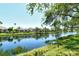 Scenic water view featuring lush landscaping and the community homes in the desirable Mira Lago neighborhood at 3870 Alamanda Dr, Sarasota, FL 34238