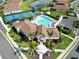 Community clubhouse and pool surrounded by manicured grounds and palm trees at 412 Daylily Blvd, Nokomis, FL 34275
