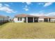Expansive backyard showcasing a well-maintained lawn and a lovely screened-in patio, perfect for Gathering gatherings and outdoor enjoyment at 412 Daylily Blvd, Nokomis, FL 34275