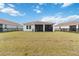 Lush backyard with an open patio area, enclosed by a sleek black fence, providing a private space for relaxation and entertainment at 412 Daylily Blvd, Nokomis, FL 34275