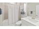 Well-lit bathroom with a shower/tub combination, white shower curtain, and single vanity at 412 Daylily Blvd, Nokomis, FL 34275