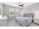 Serene bedroom with neutral tones, plantation shutters, and a ceiling fan, creating a relaxing retreat at 412 Daylily Blvd, Nokomis, FL 34275