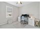 Office space with a light gray chair, dual monitors, a window, and a ceiling fan at 412 Daylily Blvd, Nokomis, FL 34275