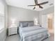Comfortable bedroom with a ceiling fan, soft lighting, and access to an en-suite bathroom at 412 Daylily Blvd, Nokomis, FL 34275