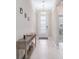 Inviting hallway with light tile floors, console table, and decorative front door at 412 Daylily Blvd, Nokomis, FL 34275
