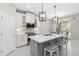 Stylish kitchen island with a quartz countertop, pendant lighting, and seating, great for entertaining at 412 Daylily Blvd, Nokomis, FL 34275