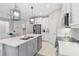 Well-equipped kitchen featuring a central island, stainless steel appliances, and modern finishes at 412 Daylily Blvd, Nokomis, FL 34275