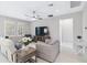Cozy living room with neutral palette, a ceiling fan, and views of the windows at 412 Daylily Blvd, Nokomis, FL 34275