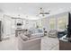 Open-concept living room flows to the dining area and kitchen, filled with natural light at 412 Daylily Blvd, Nokomis, FL 34275
