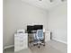 Bright home office featuring a vaulted ceiling, neutral decor, and modern computer equipment at 412 Daylily Blvd, Nokomis, FL 34275