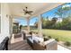 Relaxing screened patio with cozy seating and an open view of the beautifully maintained lawn and peaceful backyard landscape at 412 Daylily Blvd, Nokomis, FL 34275