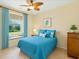 Bright bedroom with blue accents, a ceiling fan, and a cozy window seat at 4668 Tuscana Dr, Sarasota, FL 34241