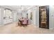 Elegant dining room with decorative door, neutral walls, tiled floor, and ornate ceiling light at 4668 Tuscana Dr, Sarasota, FL 34241