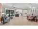 Open living space featuring tile flooring, dining table, seating area, and access to outdoor pool at 4668 Tuscana Dr, Sarasota, FL 34241