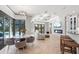 Open-concept living space featuring tile floors, a modern light fixture and backyard pool access at 4668 Tuscana Dr, Sarasota, FL 34241
