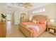 Spacious main bedroom with a ceiling fan, tile floors, and a private ensuite at 4668 Tuscana Dr, Sarasota, FL 34241