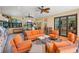 Inviting outdoor seating area featuring comfortable furniture, ceiling fans, and sliding glass door access at 4668 Tuscana Dr, Sarasota, FL 34241