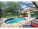 Inviting screened-in pool with spa and outdoor kitchen, perfect for relaxation and entertaining at 4668 Tuscana Dr, Sarasota, FL 34241