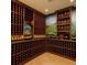 Well-stocked wine cellar with wooden racks and temperature control, ideal for wine enthusiasts at 4668 Tuscana Dr, Sarasota, FL 34241