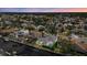 Beautiful aerial view of a waterfront home in a residential community with palm trees and screened-in pools at 4715 Spinnaker Dr, Bradenton, FL 34208