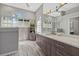 Modern bathroom featuring double sinks, decorative mirrors, and tiled floors at 4715 Spinnaker Dr, Bradenton, FL 34208