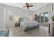 Bright and inviting bedroom with a ceiling fan, neutral tones, and access to a patio at 4715 Spinnaker Dr, Bradenton, FL 34208