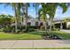 Charming home with lush landscaping, mature palm trees and meticulous landscaping, offers great curb appeal at 4715 Spinnaker Dr, Bradenton, FL 34208