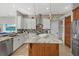 Modern kitchen with a large island, stainless appliances, granite countertops, and white cabinets at 4715 Spinnaker Dr, Bradenton, FL 34208