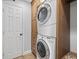 Convenient laundry room with stacked washer/dryer, custom wood cabinets and ample storage at 4715 Spinnaker Dr, Bradenton, FL 34208