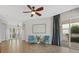 Open-concept living room with cozy seating area and an access to an outdoor patio at 4715 Spinnaker Dr, Bradenton, FL 34208