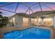Private backyard pool with screened-in lanai, brick pavers and a beautiful view of the home's exterior at 4715 Spinnaker Dr, Bradenton, FL 34208